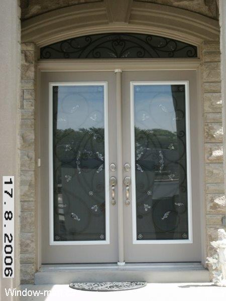 Double front door. Entry steel insulated. Full wrought iron glass inserts. Matching round top arch head transom